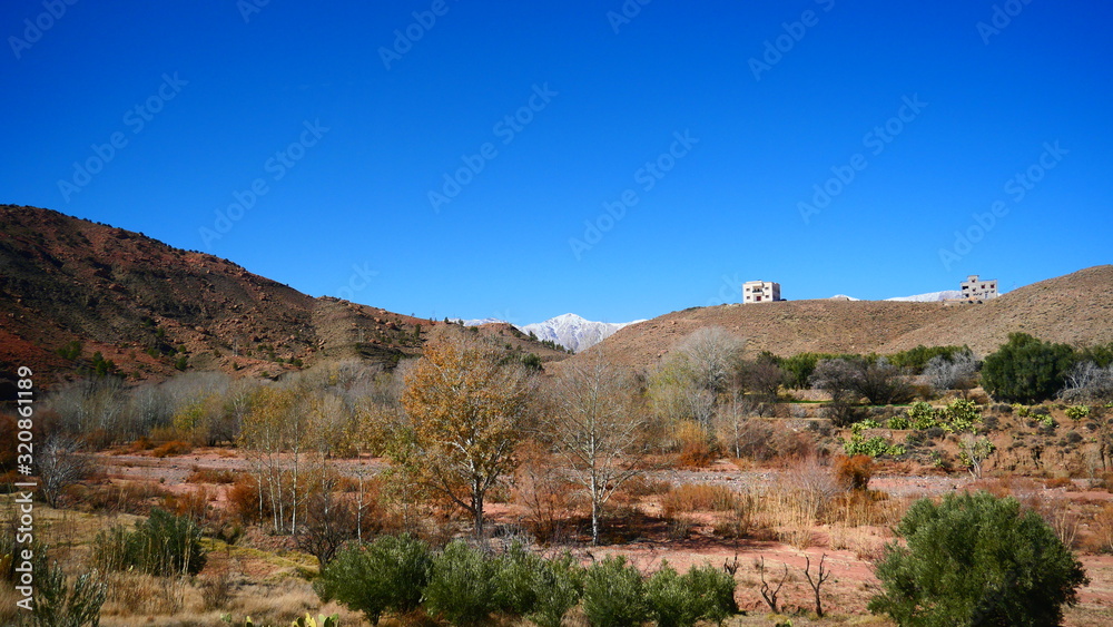 Bright landscape of Morocco, breathtaking curves of mountains, stunning combination of hills & farm land,inadvertent distribution of houses & huts, raw impression of pure nature.