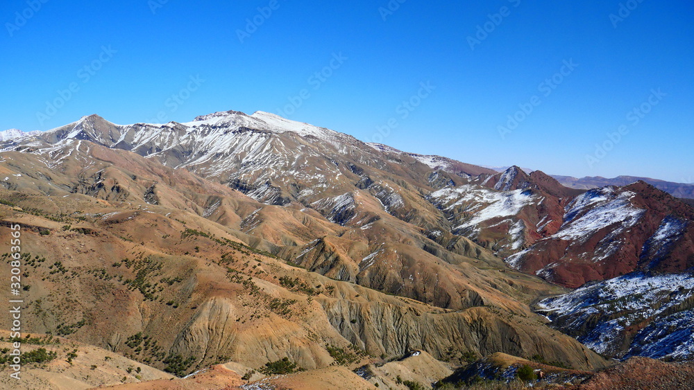 Bright landscape of Morocco, breathtaking curves of mountains, stunning combination of hills & farm land,inadvertent distribution of houses & huts, raw impression of pure nature.