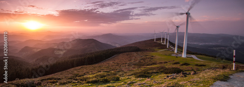 eolic generators on the mountains at sunset photo