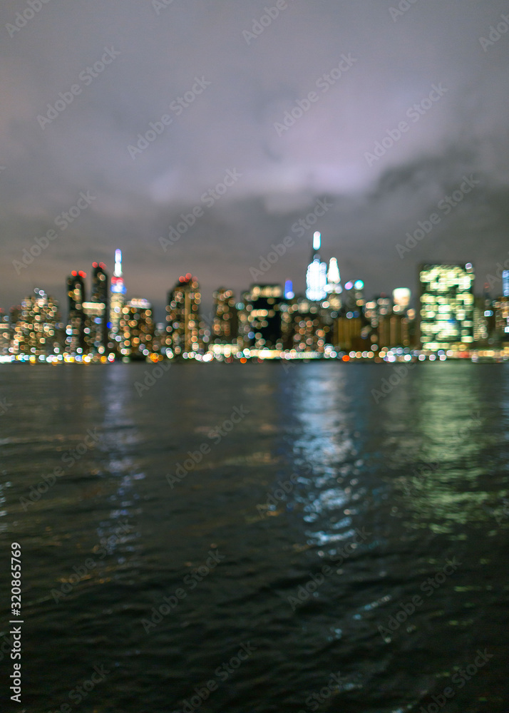 Blurred view of night Midtown Manhattan from East River