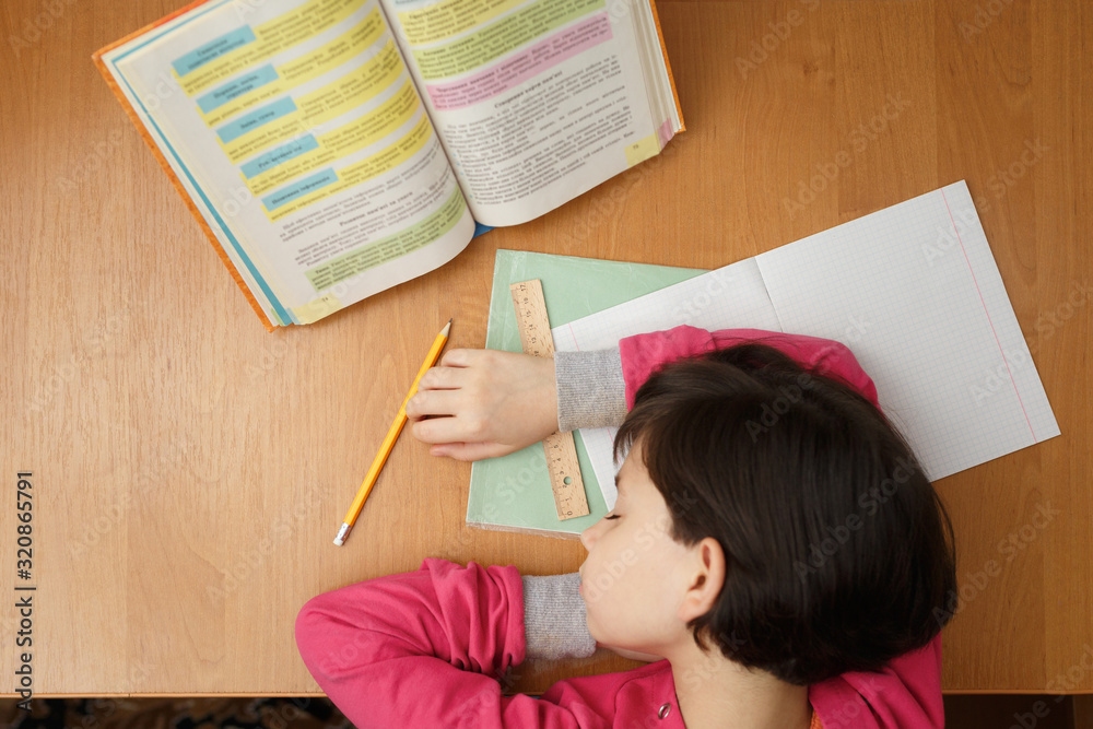 Young school girl fell asleep at school homework. Young school girl fell asleep at school homework.