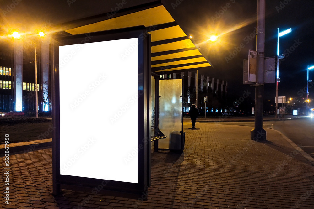 billboard in a bus stop. Advertising field at the bus stop. luminous box with an advertising field. Standing billboard in the city at night
