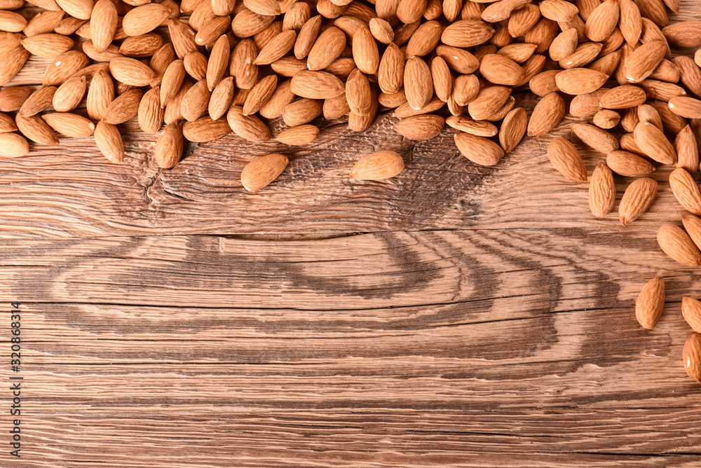 Almond nuts on wooden table top view. Fresh almonds copy space. Almond nuts on wooden table top view. Fresh almonds copy space.