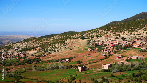 Bright landscape of Morocco, breathtaking curves of mountains, stunning combination of hills & farm land,inadvertent distribution of houses & huts, raw impression of pure nature.