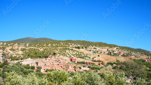 Bright landscape of Morocco, breathtaking curves of mountains, stunning combination of hills & farm land,inadvertent distribution of houses & huts, raw impression of pure nature.