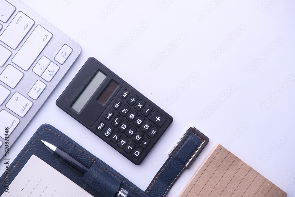 top view of calculator, diary and keyboard on white background top view of calculator, diary and keyboard on white background
