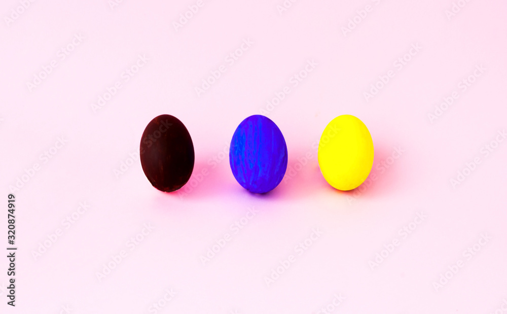 Colorful easter eggs on a pink background. Festive concept, minimalism. Close-up