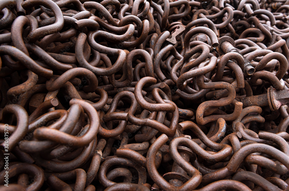 Rusty metal clips close up. Old railroad iron clips. Pile of metal Rusty metal clips close up. Old railroad iron clips. Pile of metal