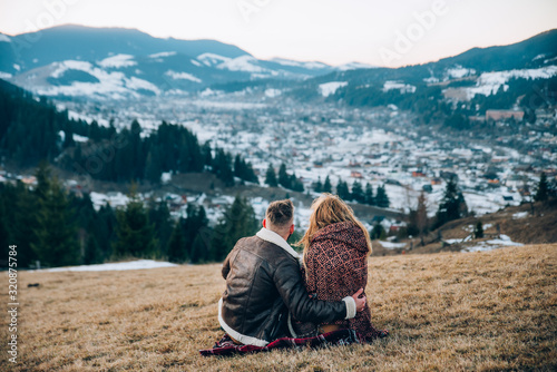 Couple of hikers with sitting looking over mountains view