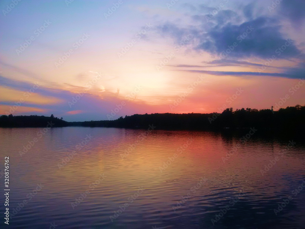 Sunrise making an orange and purple sky over the lake
