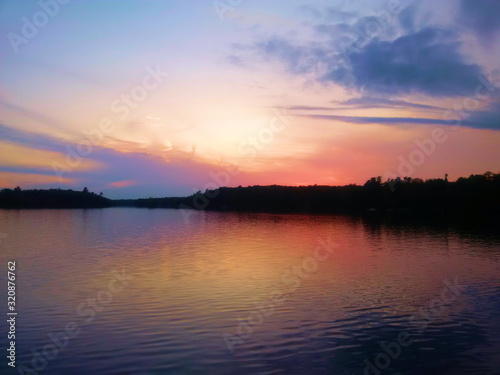 Sunrise making an orange and purple sky over the lake