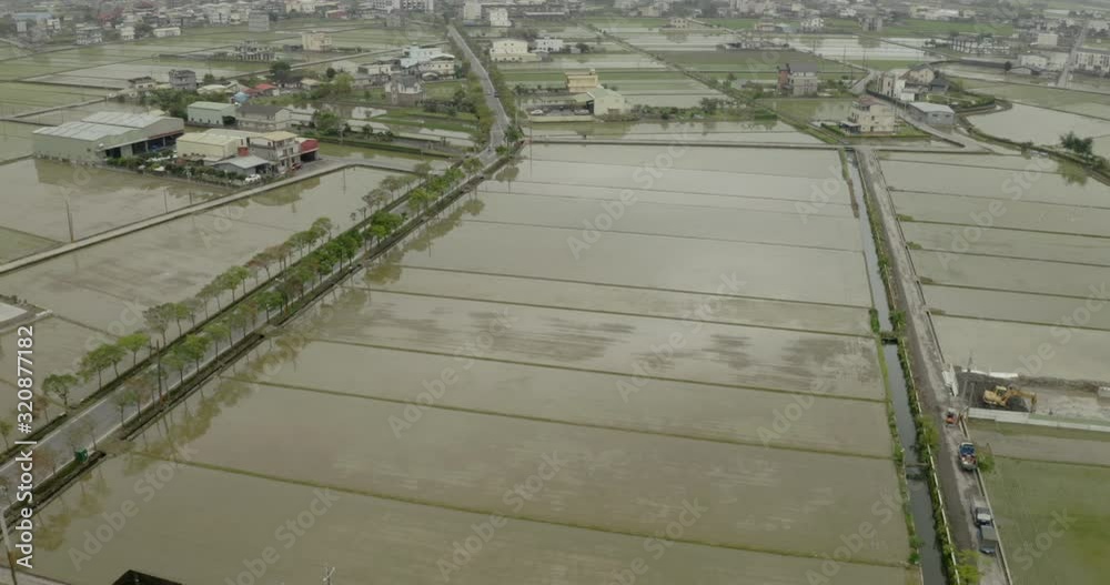 Yilan county aerial view above rice paddy fields & rural farming village settlement houses in Taiwan Yilan county aerial view above rice paddy fields & rural farming village settlement houses in Taiwan