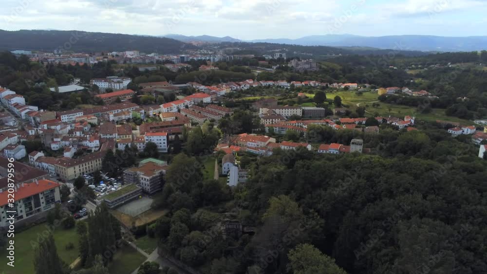 Pan left aerial view of the Cathedral and city of Santiago De Compostela The capital of Galicia in north western Spain on a beautiful clear day. Pan left aerial view of the Cathedral and city of Santiago De Compostela The capital of Galicia in north western Spain on a beautiful clear day.