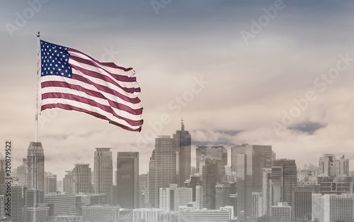 American flag against city background