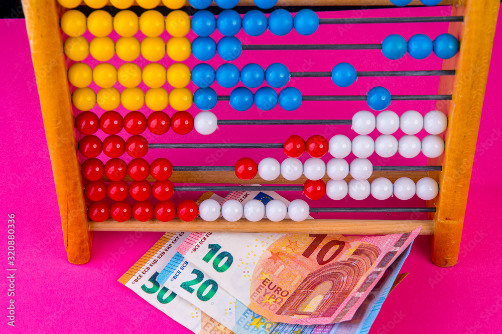 Purple background with abacus and euro banknotes Purple background with abacus and euro banknotes
