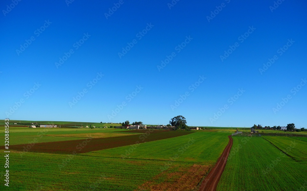 Bright landscape of Morocco, breathtaking curves of mountains, stunning combination of hills & farm land,inadvertent distribution of houses & huts, raw impression of pure nature.