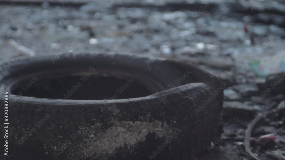 Old black tire dumped in dirty grunge building Old black tire dumped in dirty grunge building