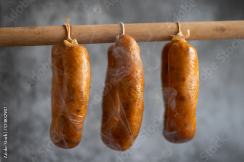 portuguese smoked sausages alheira on wooden stick photo