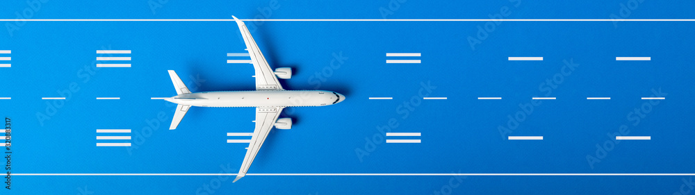 White plane, airplane on blue color runway background. Top view, flat lay. Summer travel, vacation concept. Banner - obrazy, fototapety, plakaty 