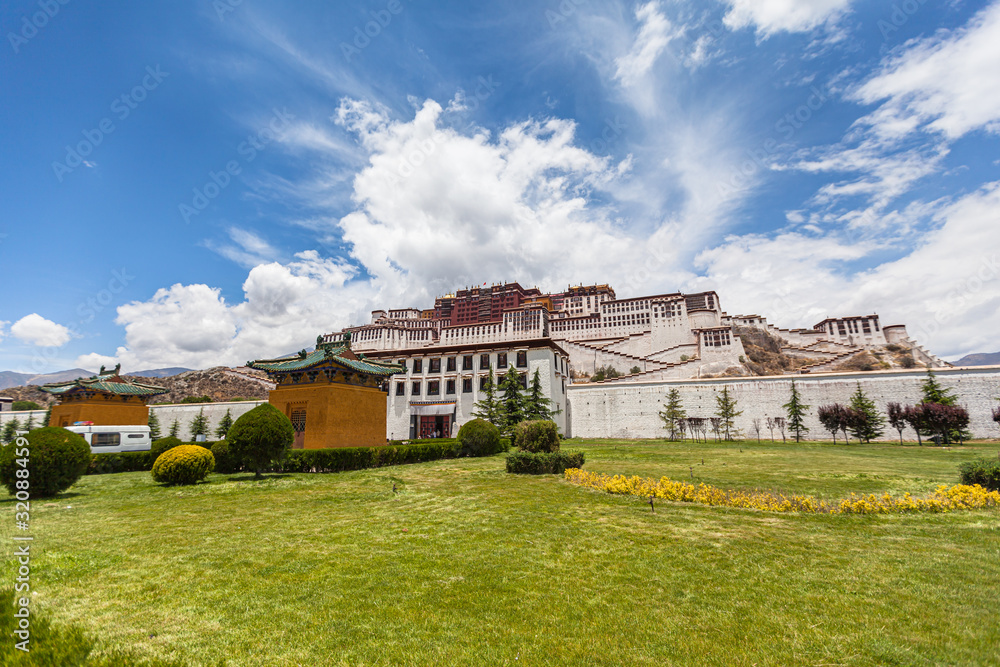 Stunning view of Potala Palace in summer sunny day, winter palace of Dalai Lama, blue sky and cloud in background, Lhasa (Lasa) of Tibet, China Stunning view of Potala Palace in summer sunny day, winter palace of Dalai Lama, blue sky and cloud in background, Lhasa (Lasa) of Tibet, China