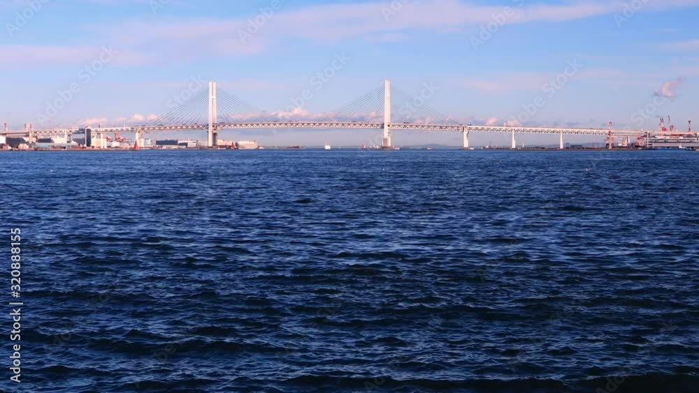 Vehicles crossing the Yokohama Bay using the bridge in the distance. Vehicles crossing the Yokohama Bay using the bridge in the distance.