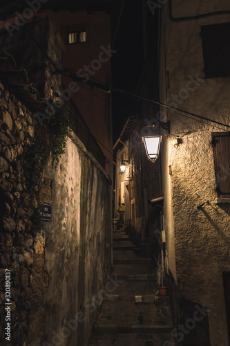 A medieval French old village alley with stairs at night lit by streetlights (Jan 10, 2020; shot at Coste Street in Puget-Theniers, France)