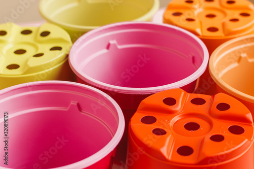 Colorful plastic pots for seedlings. .Bright round containers for planting plants..