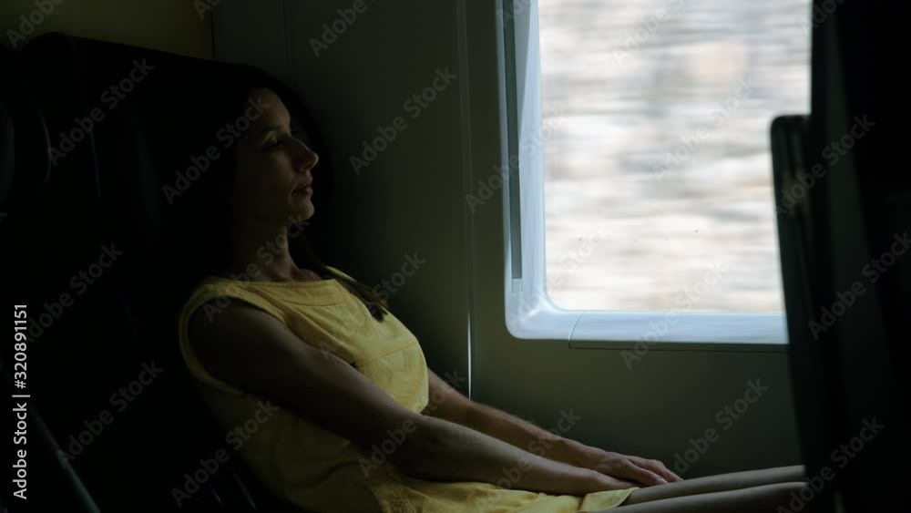 Passenger young woman sitting against window of high speed spanish train. Beautiful caucasian girl traveling on her own by bullet train. 4K Passenger young woman sitting against window of high speed spanish train. Beautiful caucasian girl traveling on her own by bullet train. 4K
