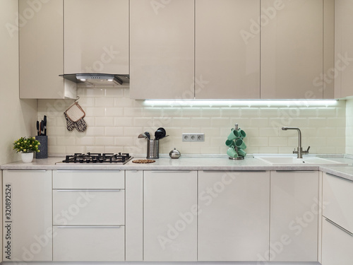 Modern white bright kitchen interior with metal grey stove