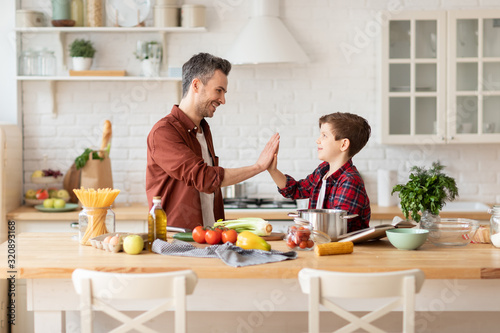 Happy father and son family on kitchen portrait