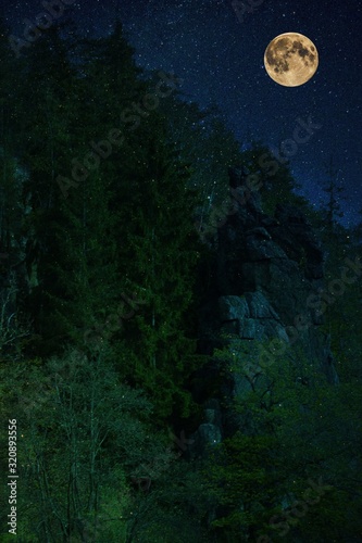 Svatosske rocks above the river Ohre in the night. Is a full moon.Amazing nature - Svatošské rocks in the Czech Republic under the night starry sky with a full moon. © luckakcul