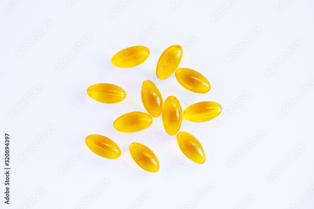 Yellow capsules with oil on a white background. Medicines and nutritional supplements. Yellow capsules with oil on a white background. Medicines and nutritional supplements.