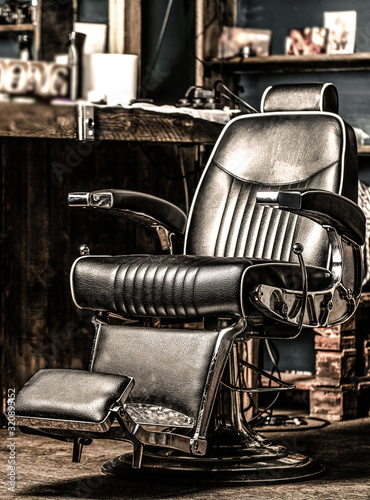 Professional hairstylist in barbershop interior. Barber shop chair. Barbershop armchair, modern hairdresser and hair salon. Beard, bearded man. Stylish vintage barber chair. Black and white