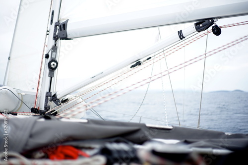 Bild auf Leinwand Detail of a moving sailboat with main mast and rigging