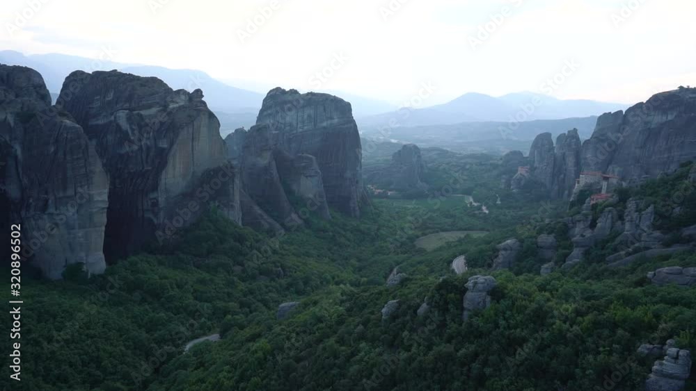 pan left reveal sunset over rock pillars