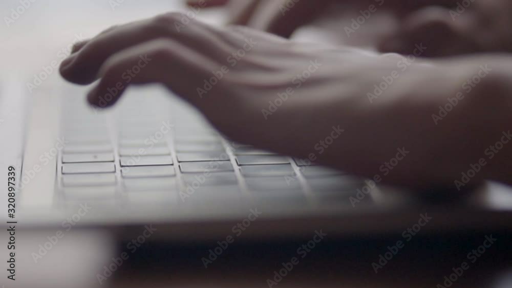 woman hands typing on a laptop working at the office close up shot