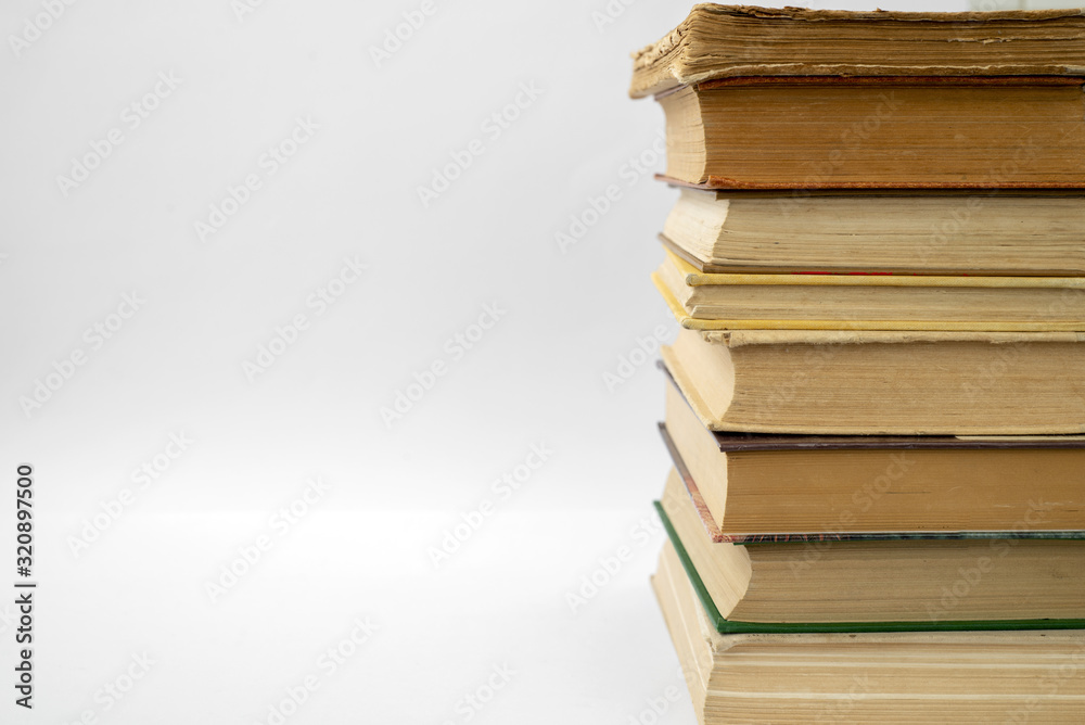 Old books on a light wall background Old books on a light wall background