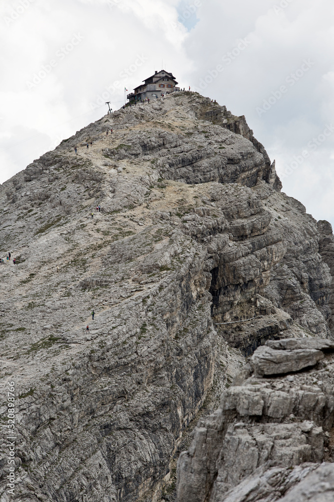 Hiking Dolomites mountains of Passo Giau. Peaks in South Tyrol in the Alps of Europe. Alpine house Hiking Dolomites mountains of Passo Giau. Peaks in South Tyrol in the Alps of Europe. Alpine house