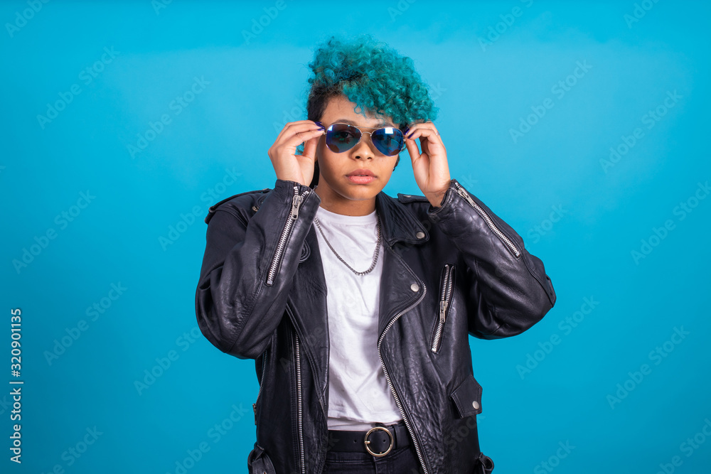 girl with blue afro american hair sunglasses isolated on blue background with fur jacket girl with blue afro american hair sunglasses isolated on blue background with fur jacket