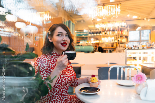 Beautiful Brunette Woman Celebrating Saint Valentine Day Alone With Cupcake In Stylish Cafe. photo