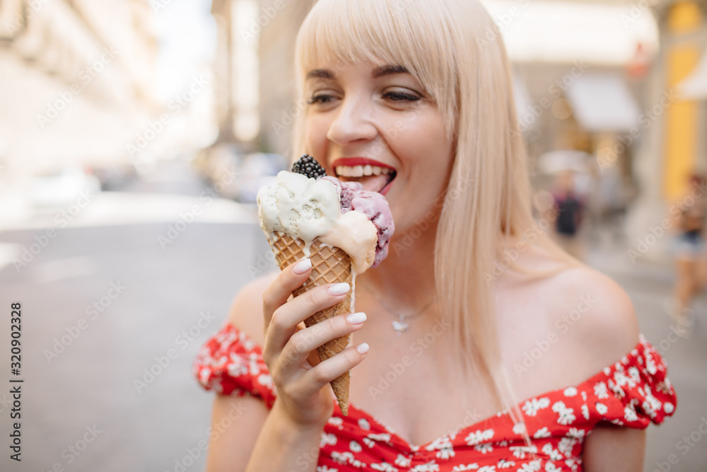 Pretty blonde girl eating delicious ice cream.