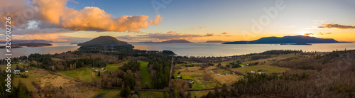 Aerial Panoramic View of Lummi island During a Glorious Sunset. Located in the Salish Sea  Orcas Island can be seen on the right with Bellingham Bay on the left. 