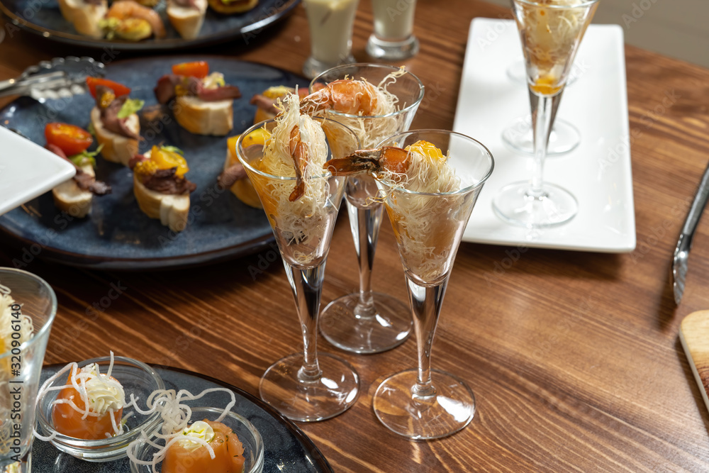 Fototapeta premium Shrimps wrapped in wheat thread and baked. Catering, beautiful table.