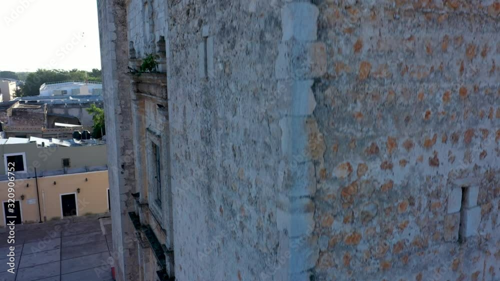 Extreme closeup aerial ascent on corner of the backlit Cathedral de San Gervasio in Valladolid, Yucatan, Mexico. Extreme closeup aerial ascent on corner of the backlit Cathedral de San Gervasio in Valladolid, Yucatan, Mexico.
