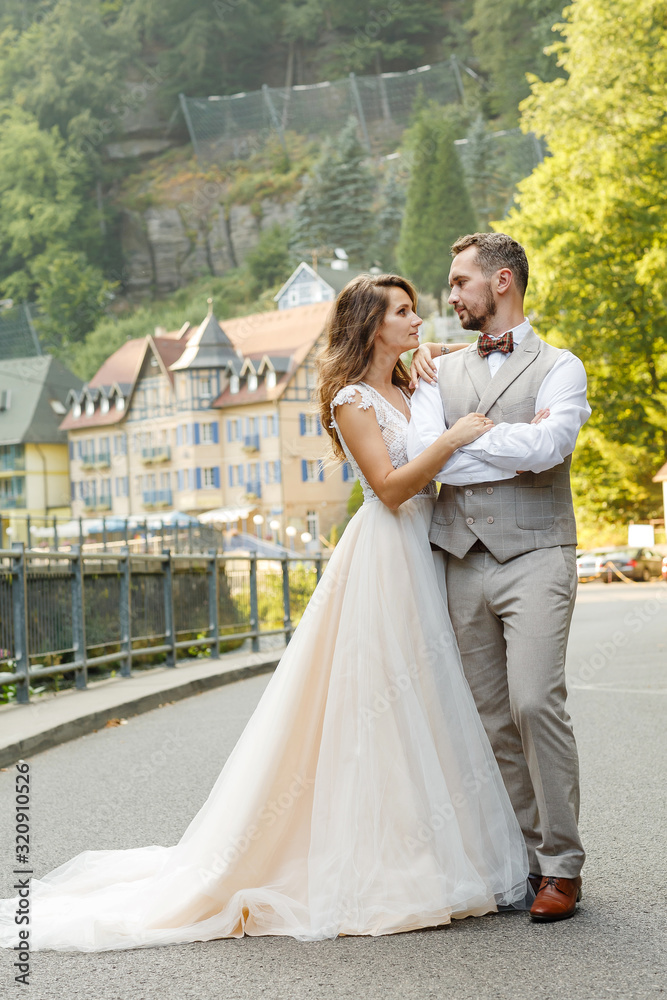 A couple of newlyweds walking near the hotel in the mountains