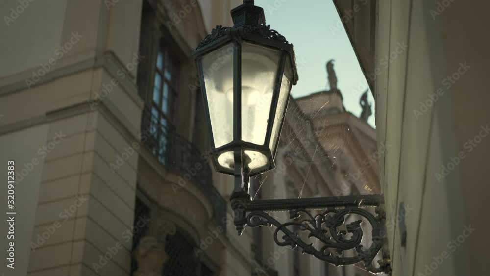 Street lantern in Prague. Web on the lantern. Old retro lantern. Street lantern in Prague. Web on the lantern. Old retro lantern.