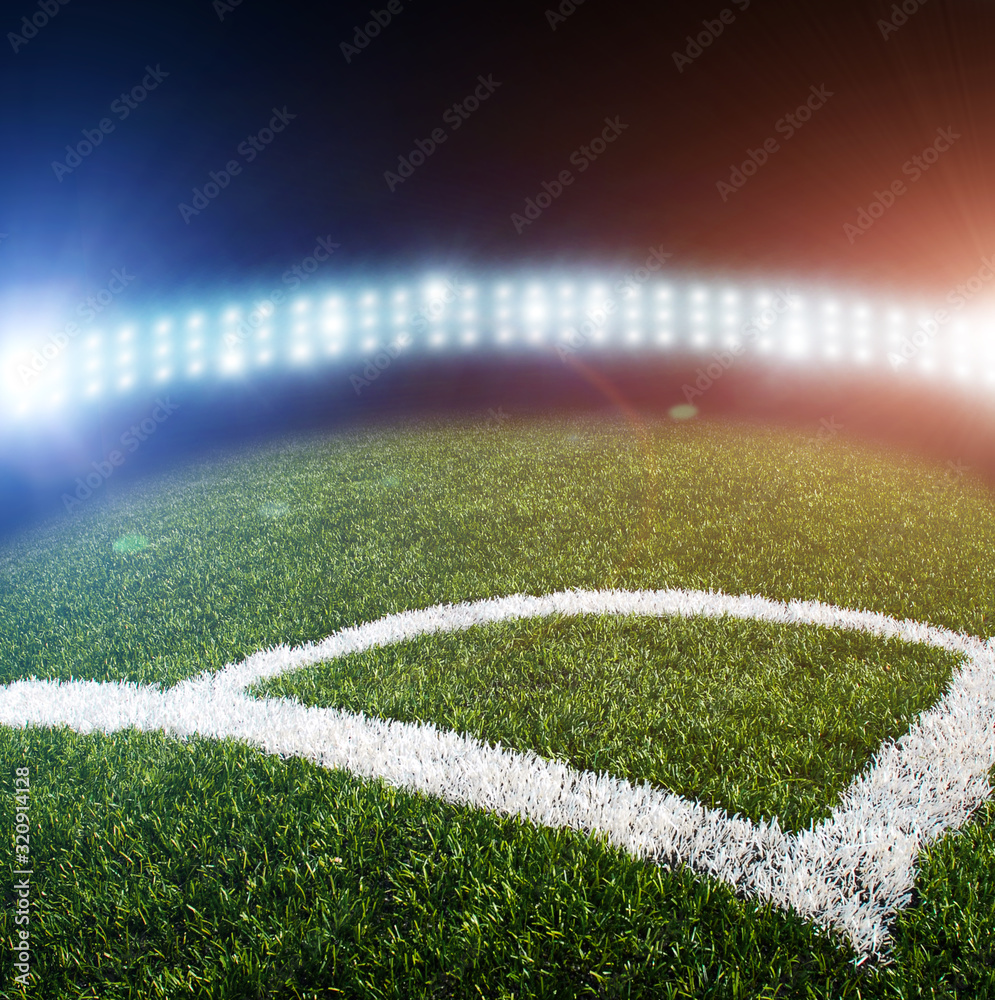 A football field corner and lights with flashes at night