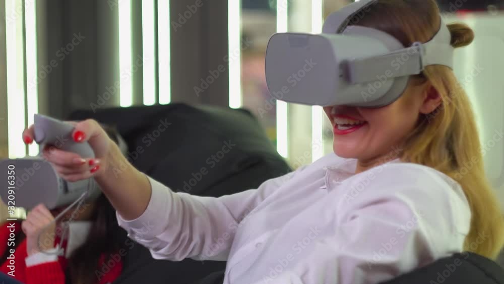 Little girl and woman playing VR simulator with glasses Little girl and woman playing VR simulator with glasses