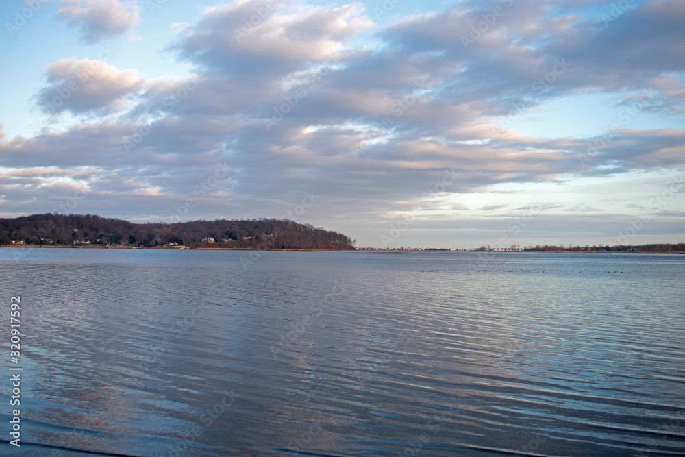 Late afternoon clouds fill the blue sky over the Navesink River at Rumson, New Jersey, USA -06
