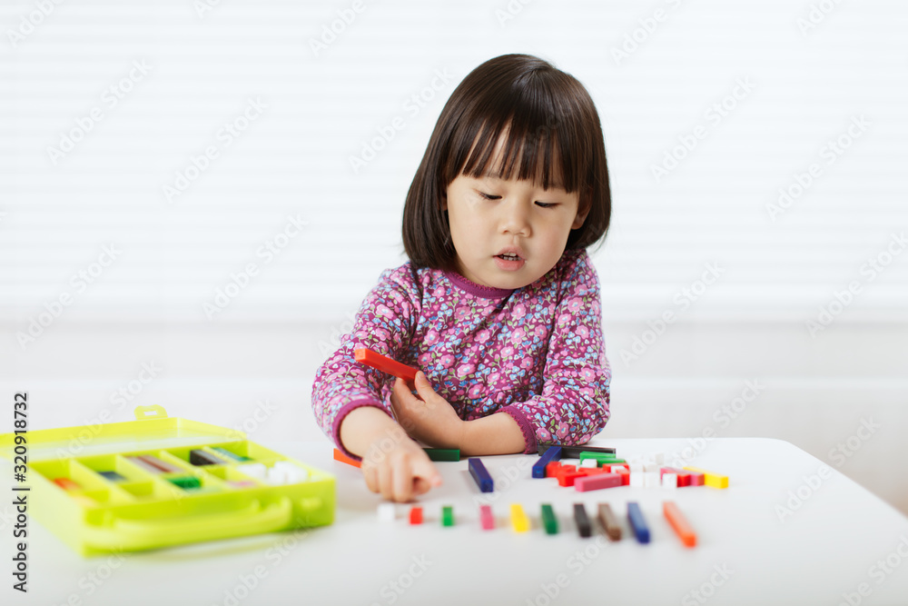 toddler girl playing creative toy blocks at home against white background toddler girl playing creative toy blocks at home against white background